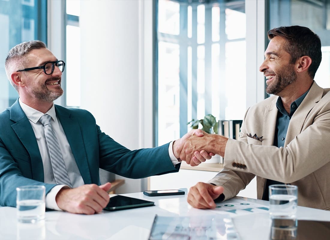 Service Center - Two Professionals Shaking Hands at a Client Meeting